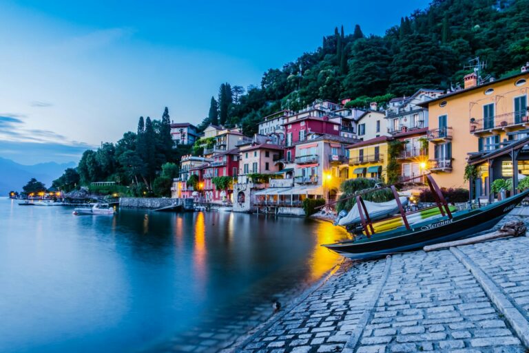 Charming lakeside view of colorful houses in Como, Italy at twilight.