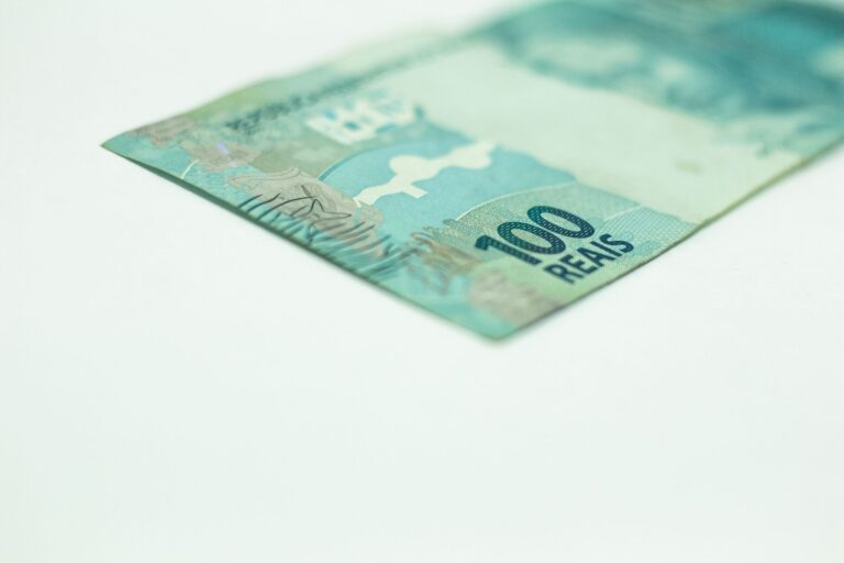 Macro shot of a Brazilian 100 Reais banknote isolated on a white background, featuring copy space.