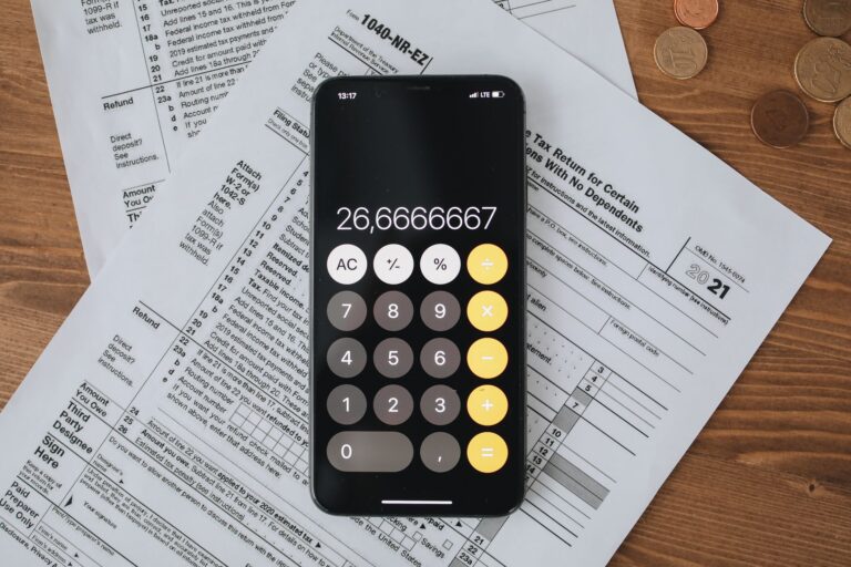 Mobile calculator app on tax documents, highlighting financial calculations and tax preparation.