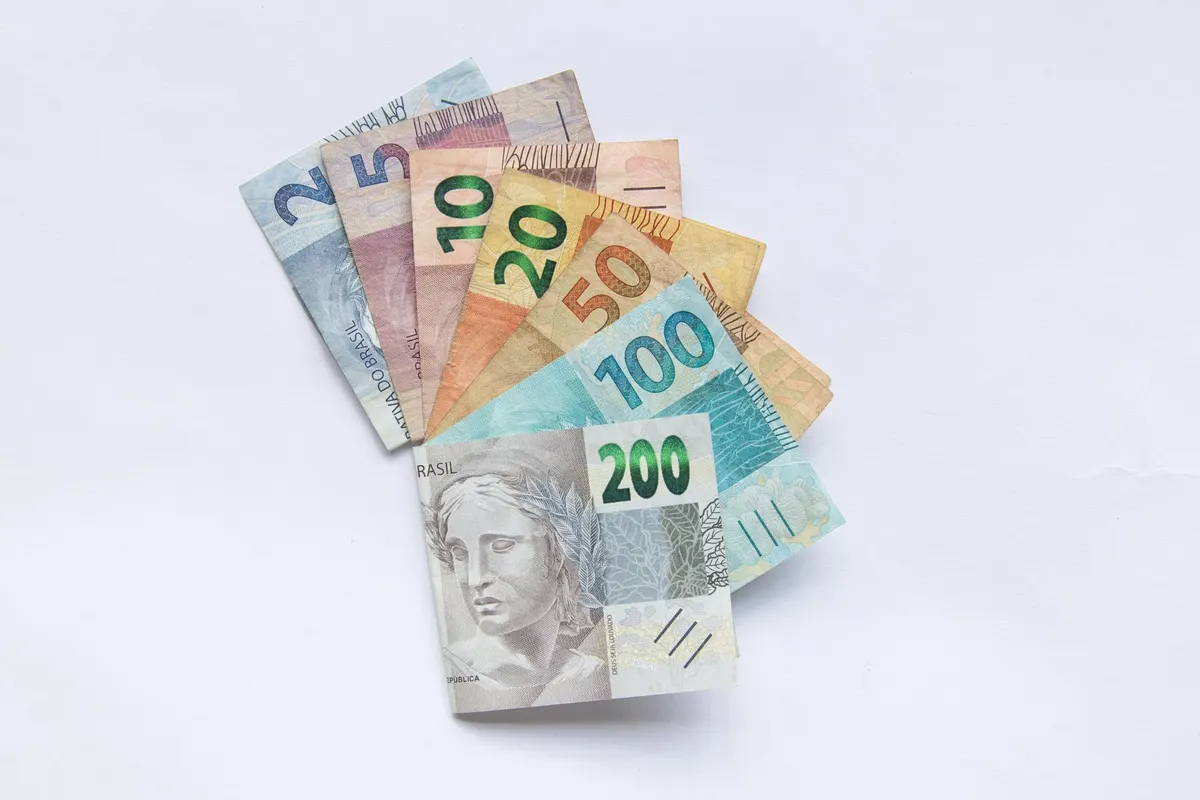 A fan arrangement of colorful Brazilian Real banknotes on a white background showcasing different values.