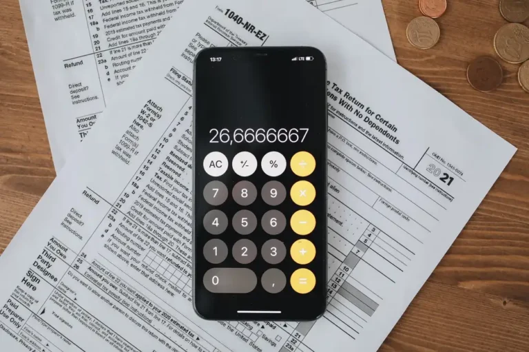 Mobile calculator app on tax documents, highlighting financial calculations and tax preparation.